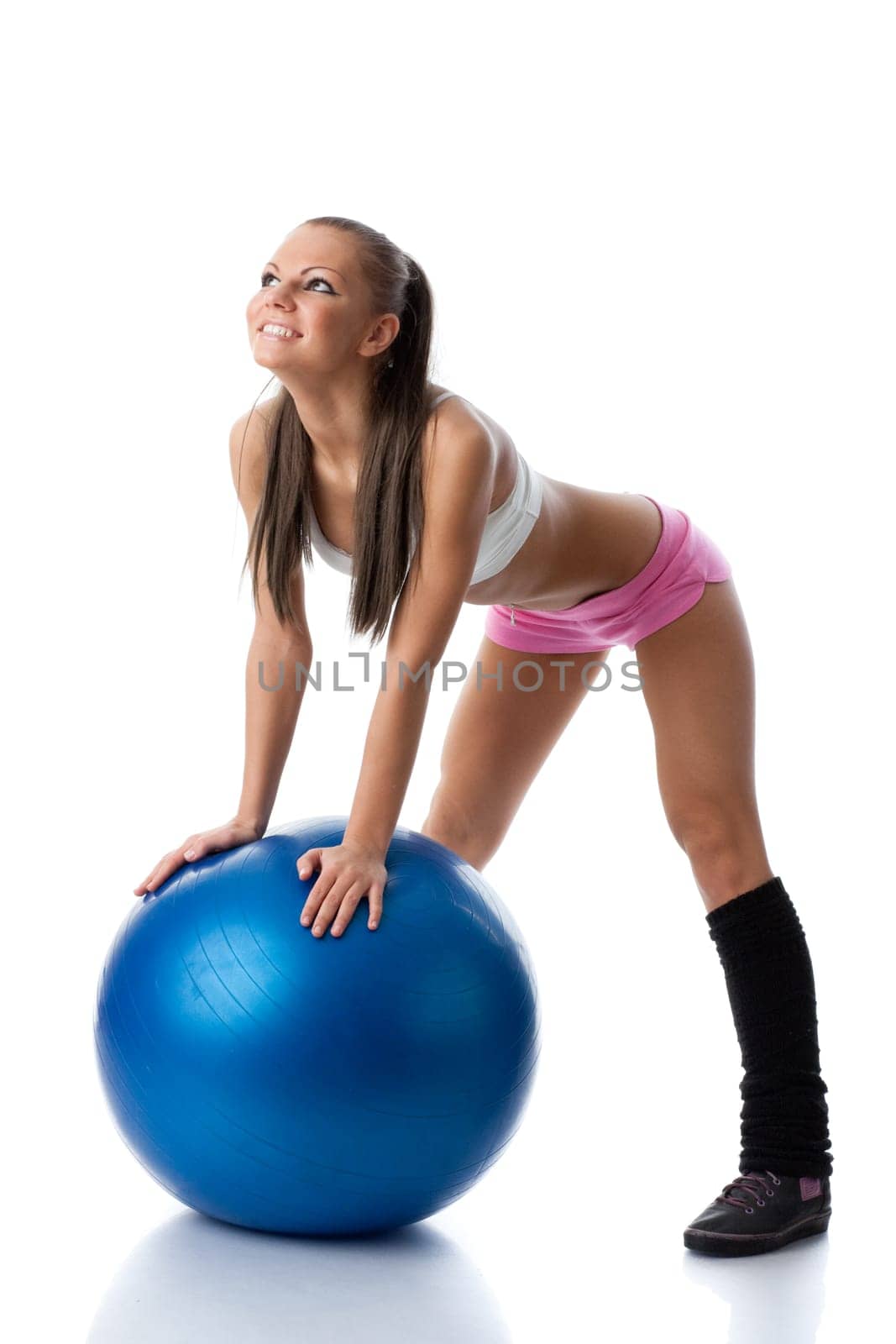 Young beautiful woman with gymnastic ball on a white background.