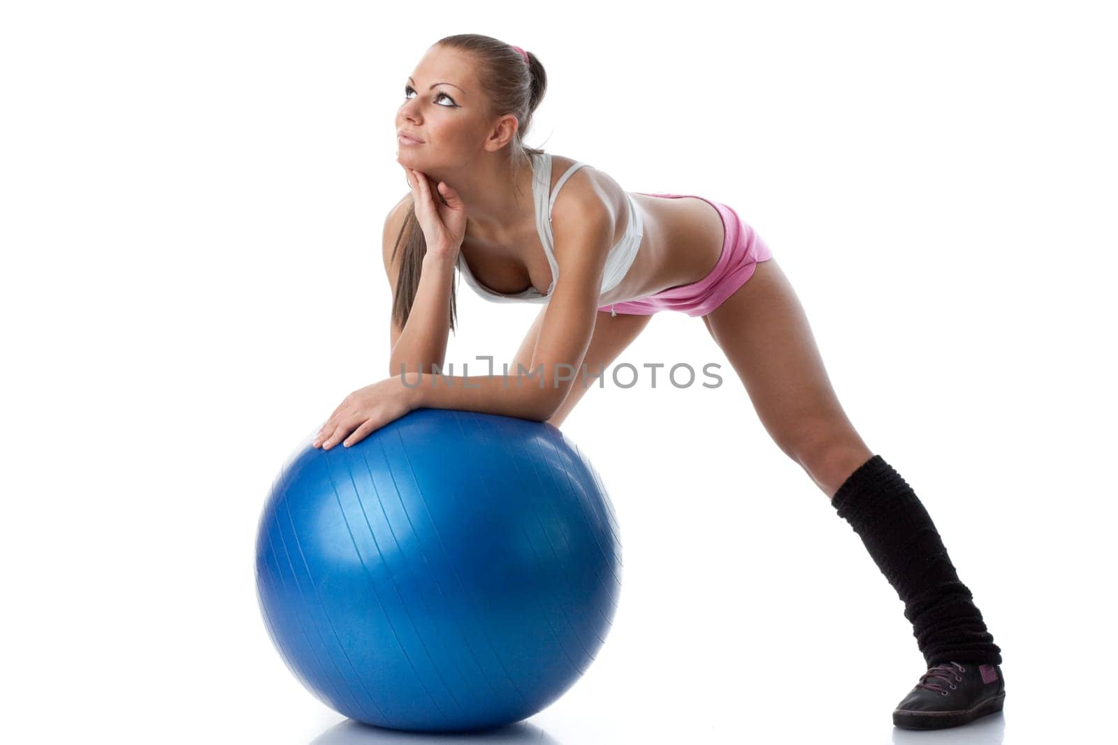 Young beautiful woman with gymnastic ball on a white background.