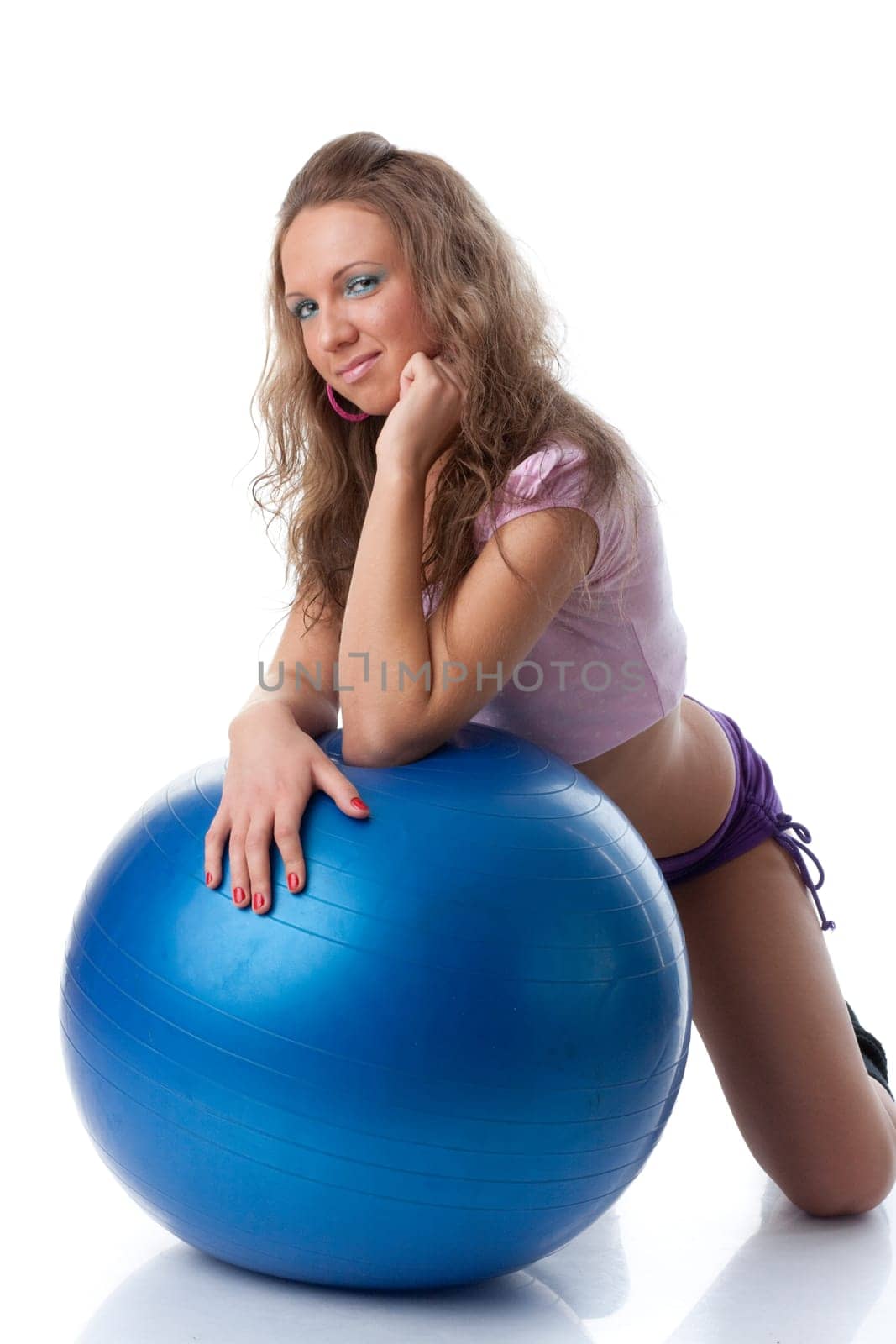 Young beautiful woman with gymnastic ball on a white background.