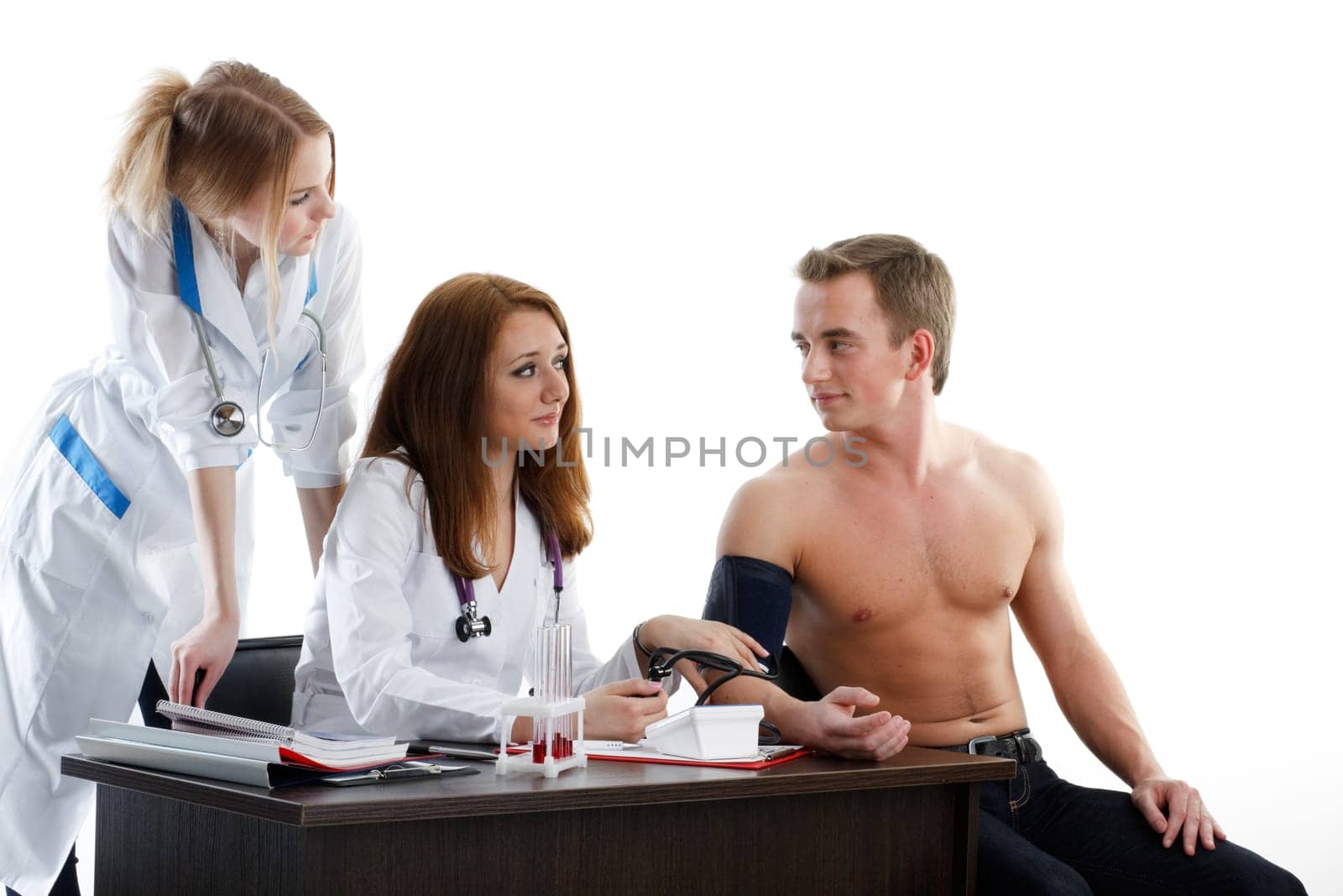 Two nurses and the young male patient on a white background.