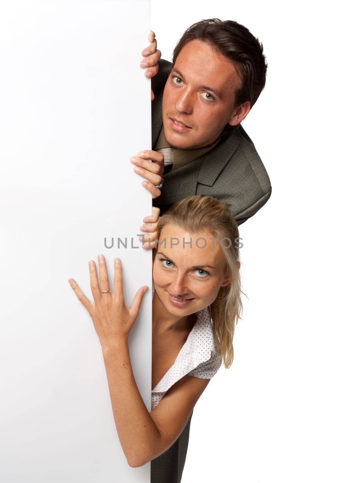 Pretty businesswoman and businessman hold an empty billboard over white background.