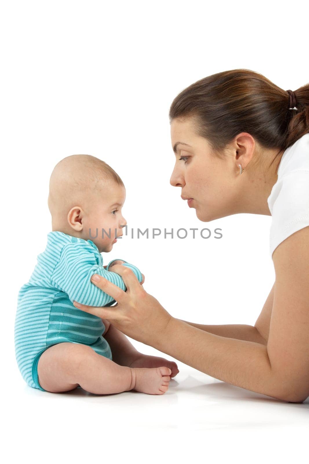 Happy mum plays with the small child a white background.