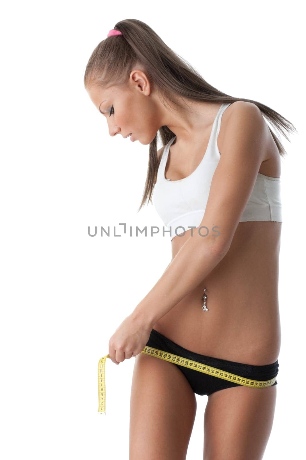 The beautiful girl measures a waist on a white background. Healthy lifestyles concept.