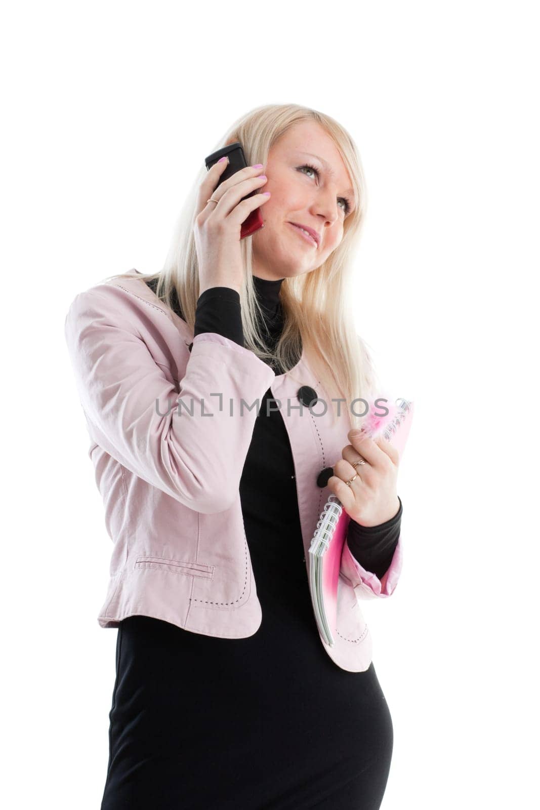 The beautiful girl stand with writing-books and mobile phone on a white background. The student.