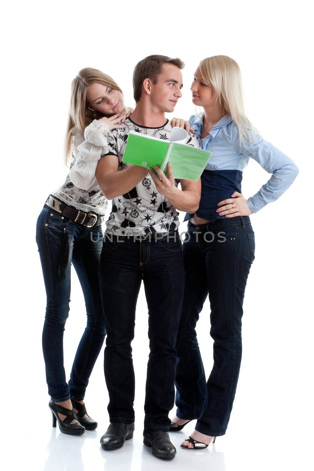 The young man and two girls with writing-books stand on a white background.