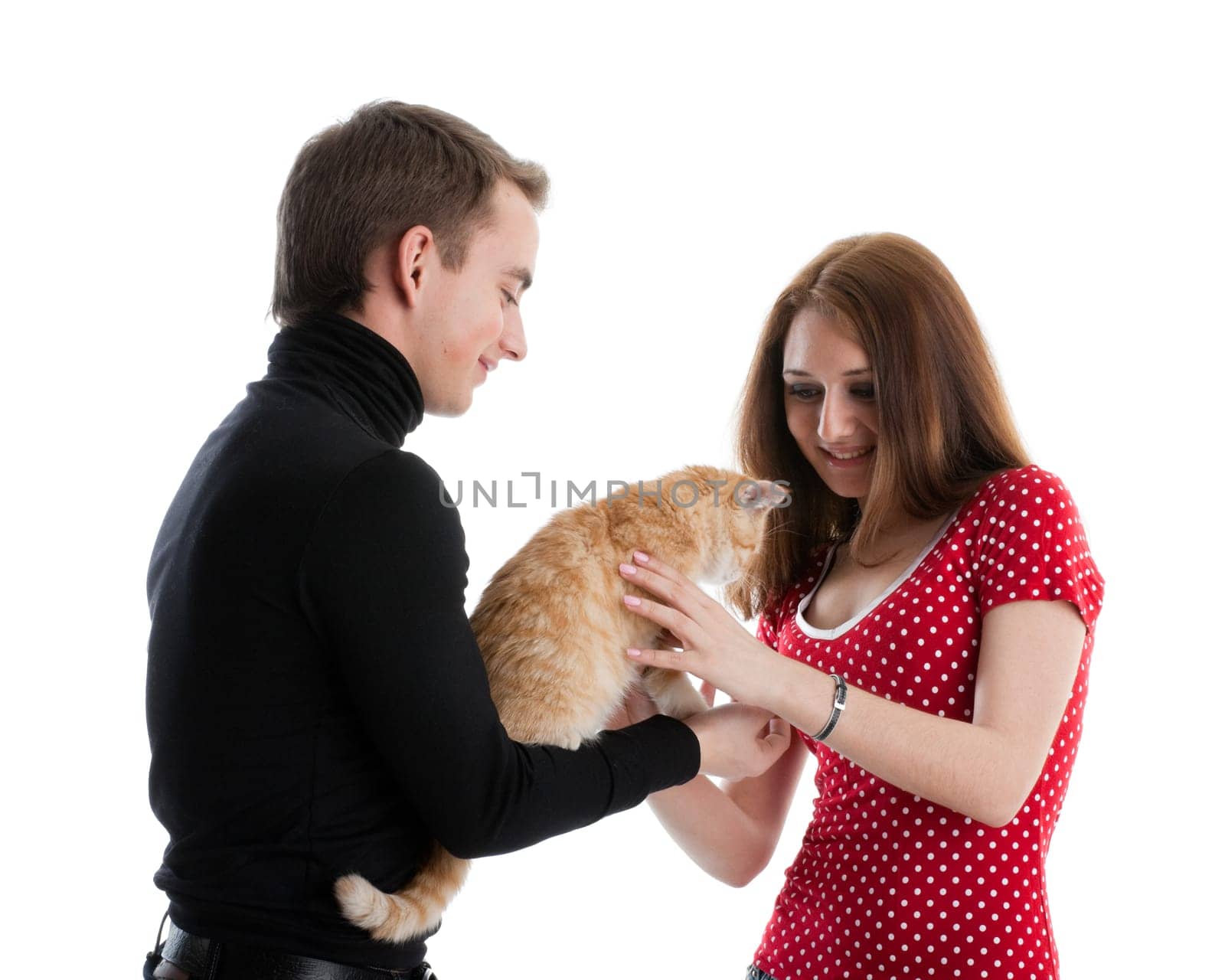 The happy young couple with a small amusing kitten on a white background.