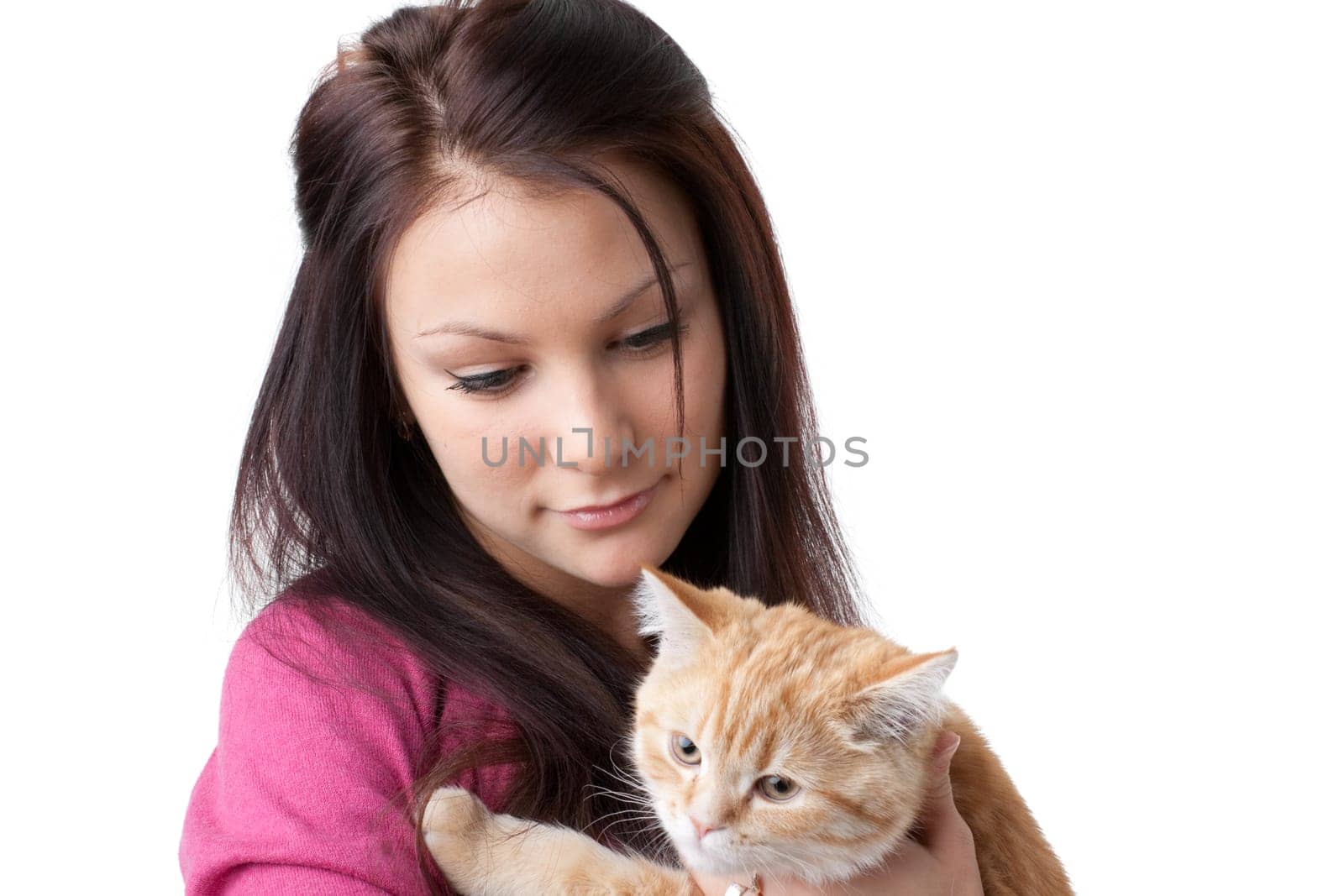 The happy young woman with a small amusing kitten on a white background.