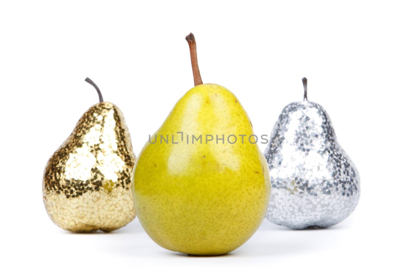 Golden, silver and natural pears on a white background. Concept for success.