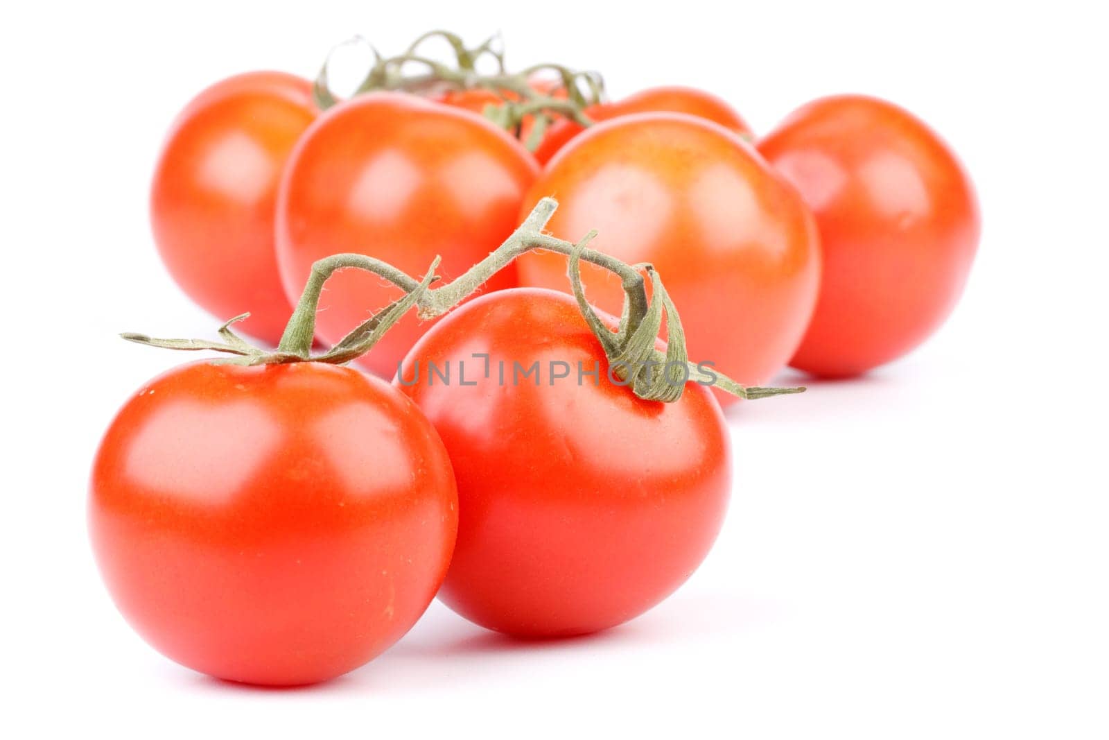 Fresh appetizing tomatoes on a white background. Close up.