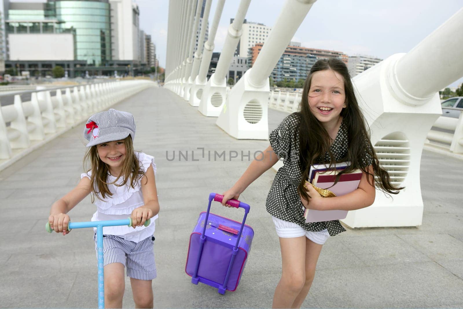 Little girls going to school with bags, books and student stuff