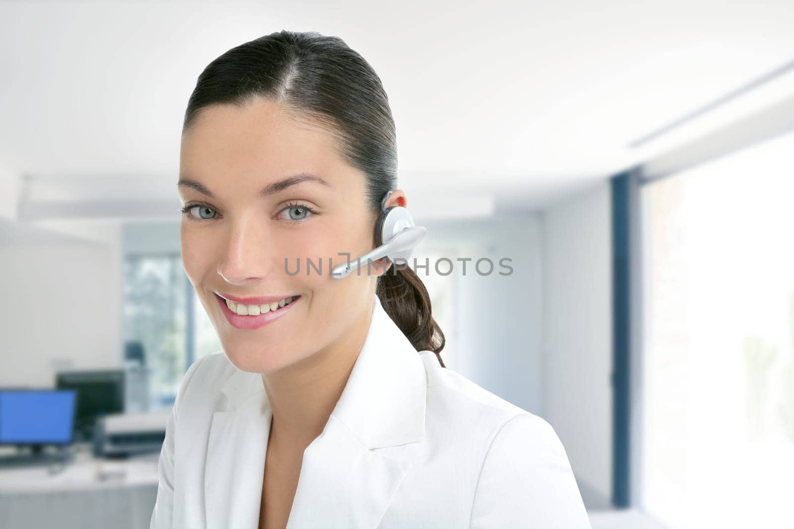 Headset phone business woman dress in white indoor modern office