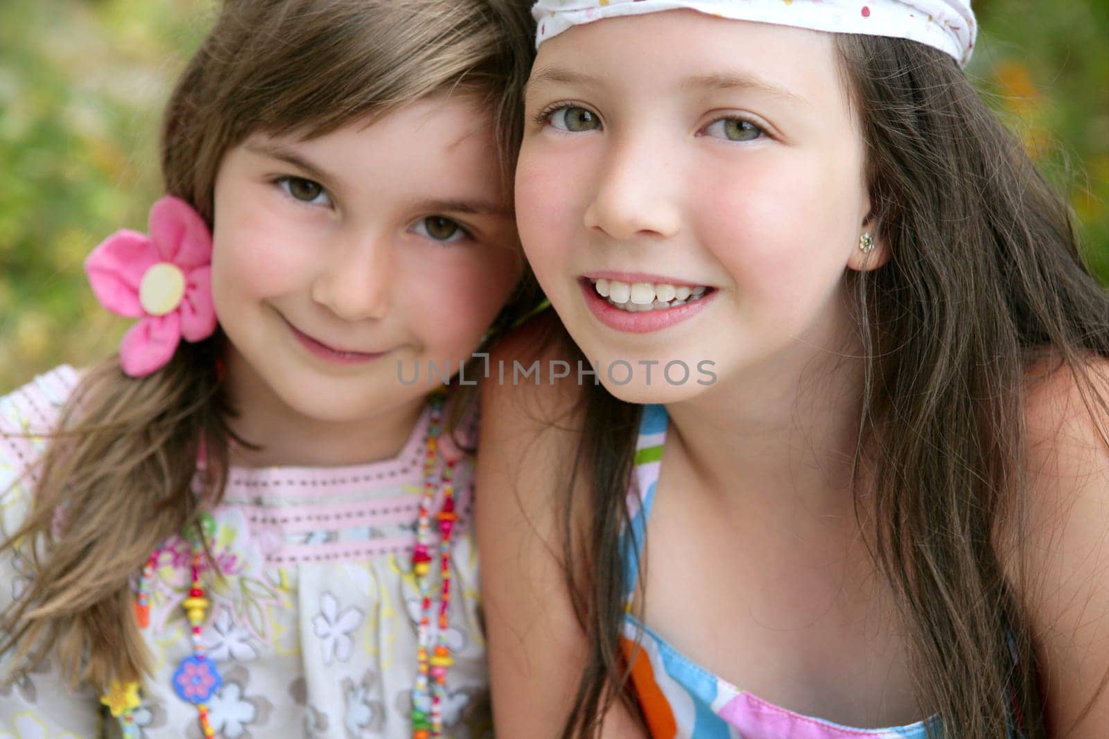 closeup portrait of two little happy beautiful girl sisters