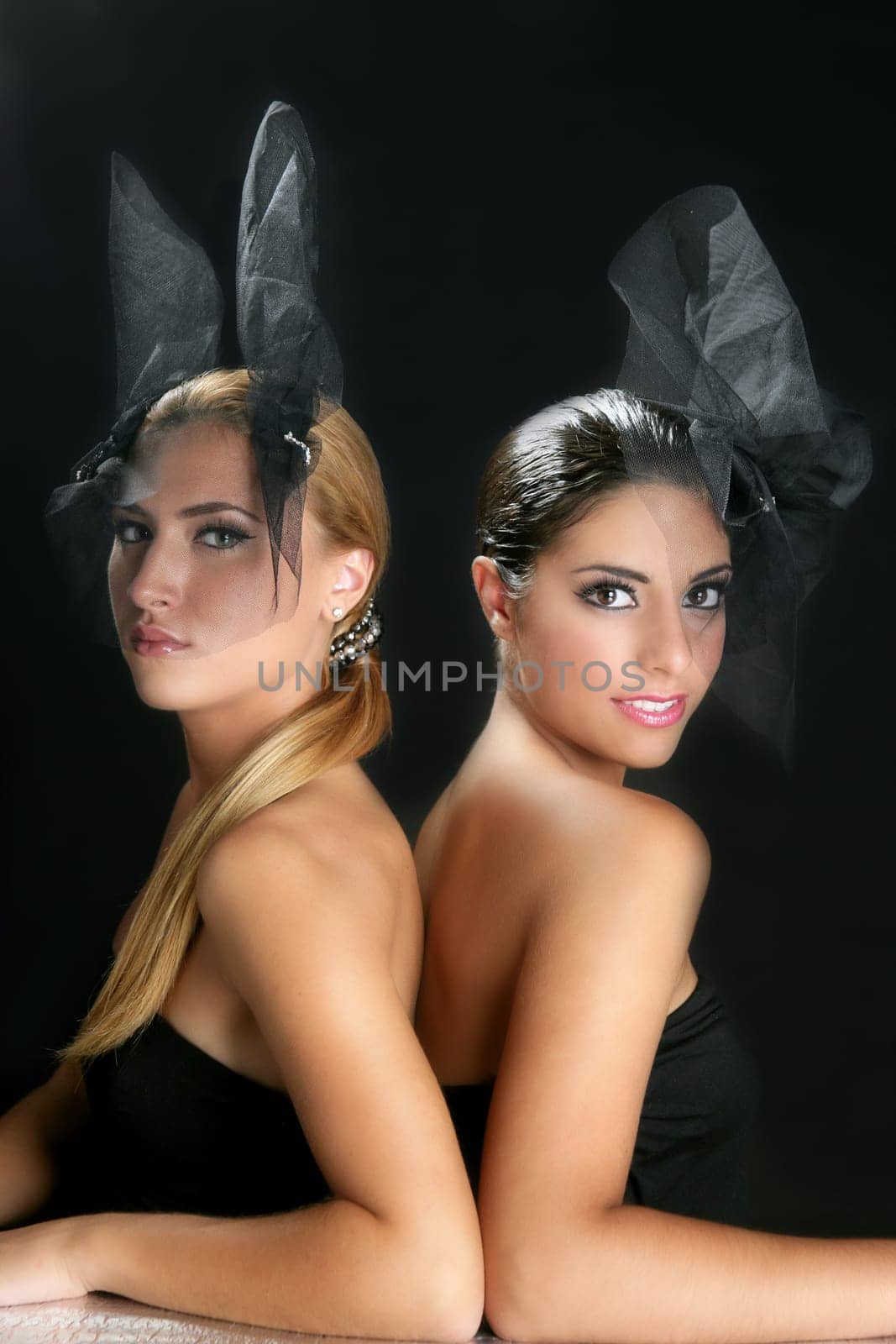 Beautiful fashion two women with veil over black