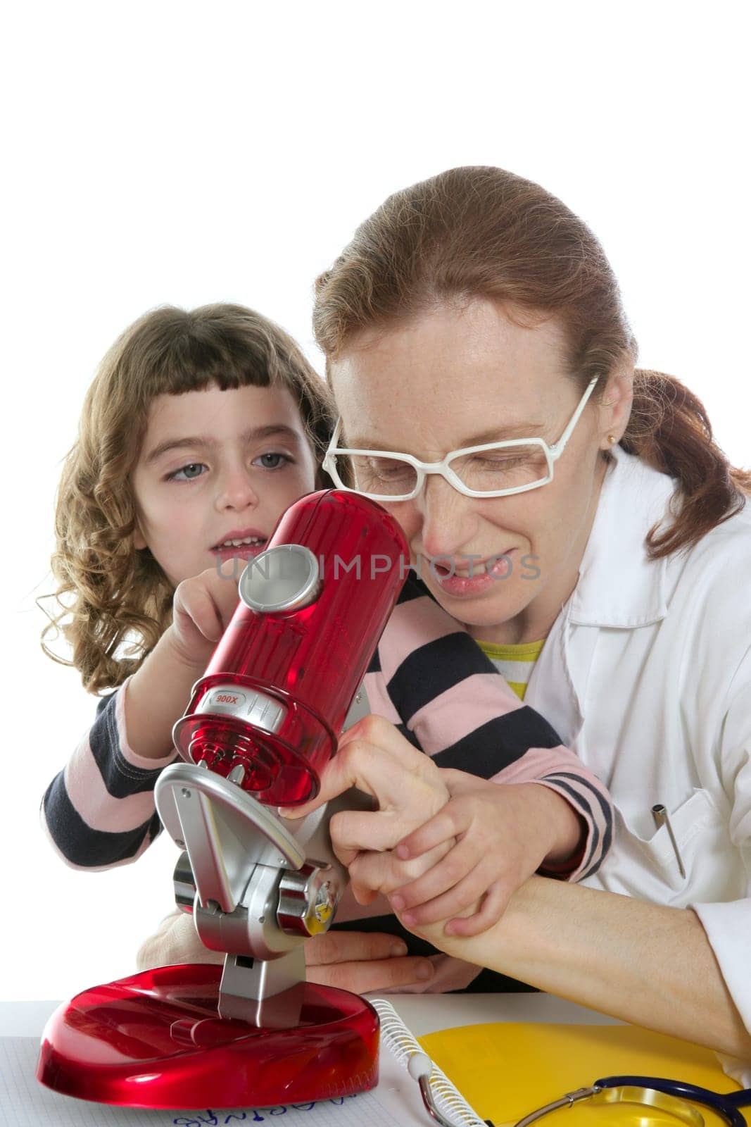 Doctor woman teacher and pupil looking toy microscope