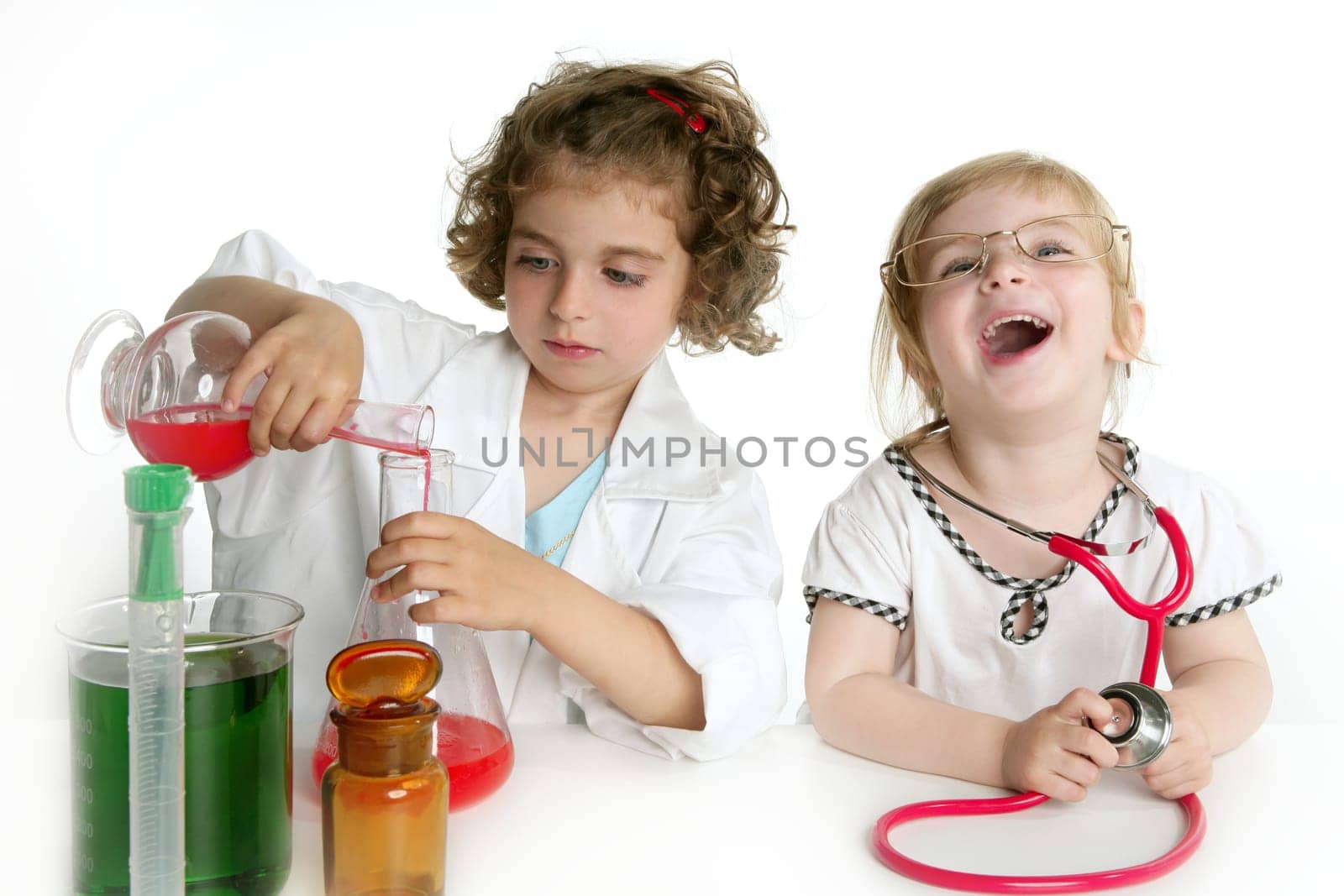 Two girls pretending to be doctor in the laboratory
