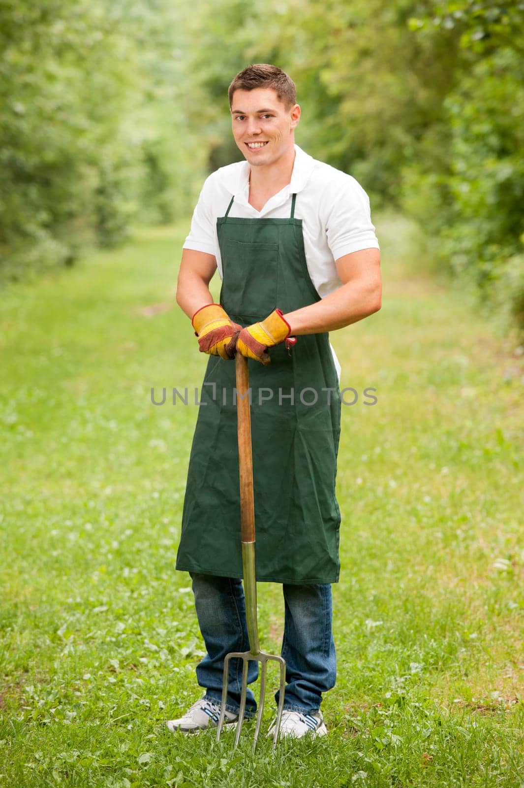 Young gardener with a compost fork