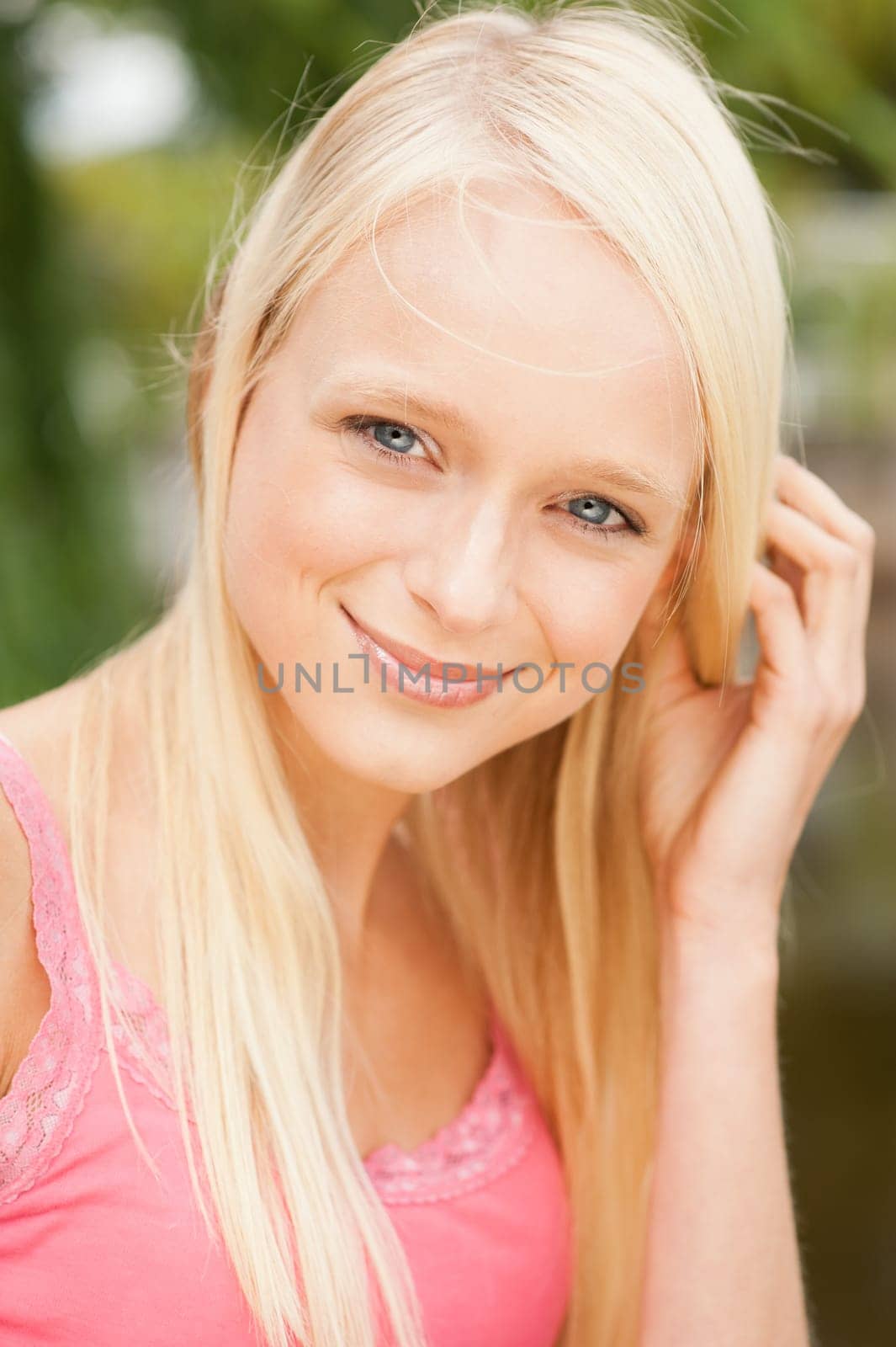 Portrait of a young and smiling woman in the park