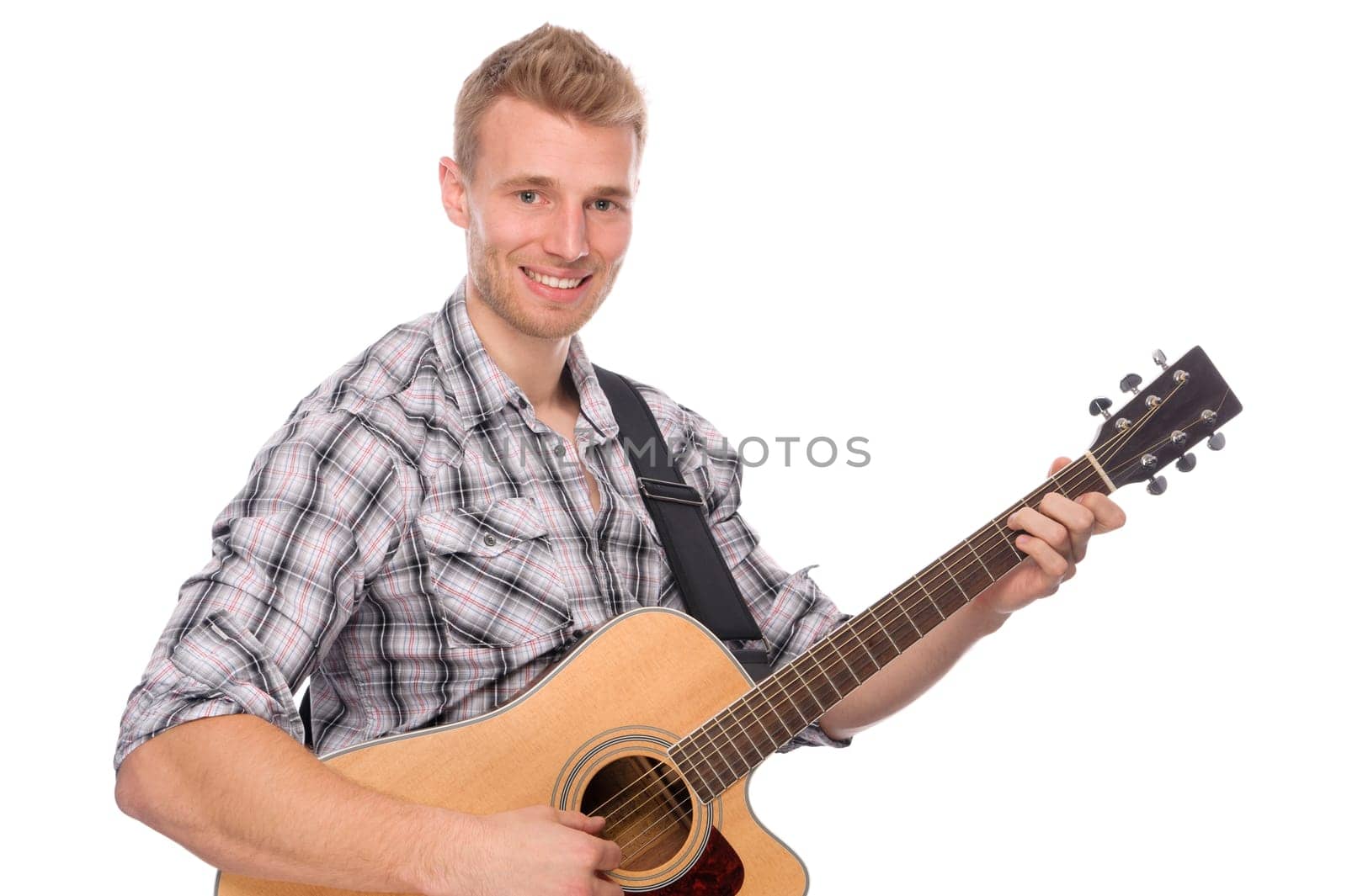 Studio shot of a young man with a guitar