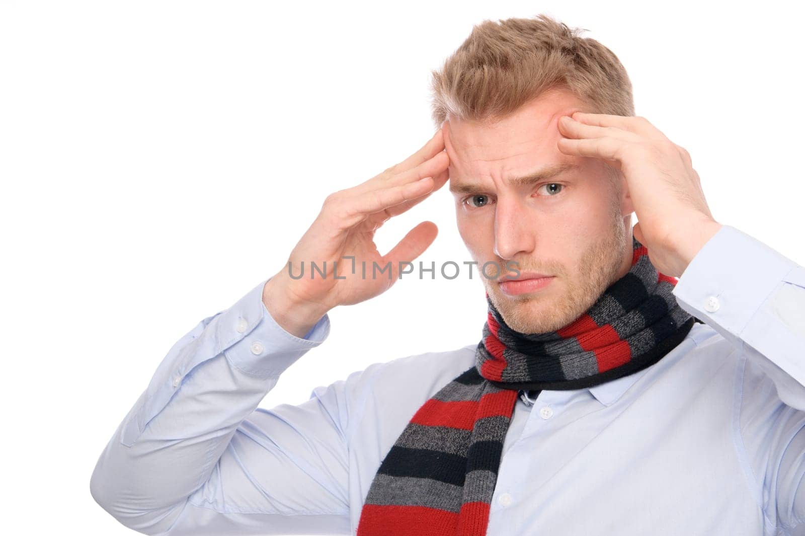 Studio shot of a young man with a headache