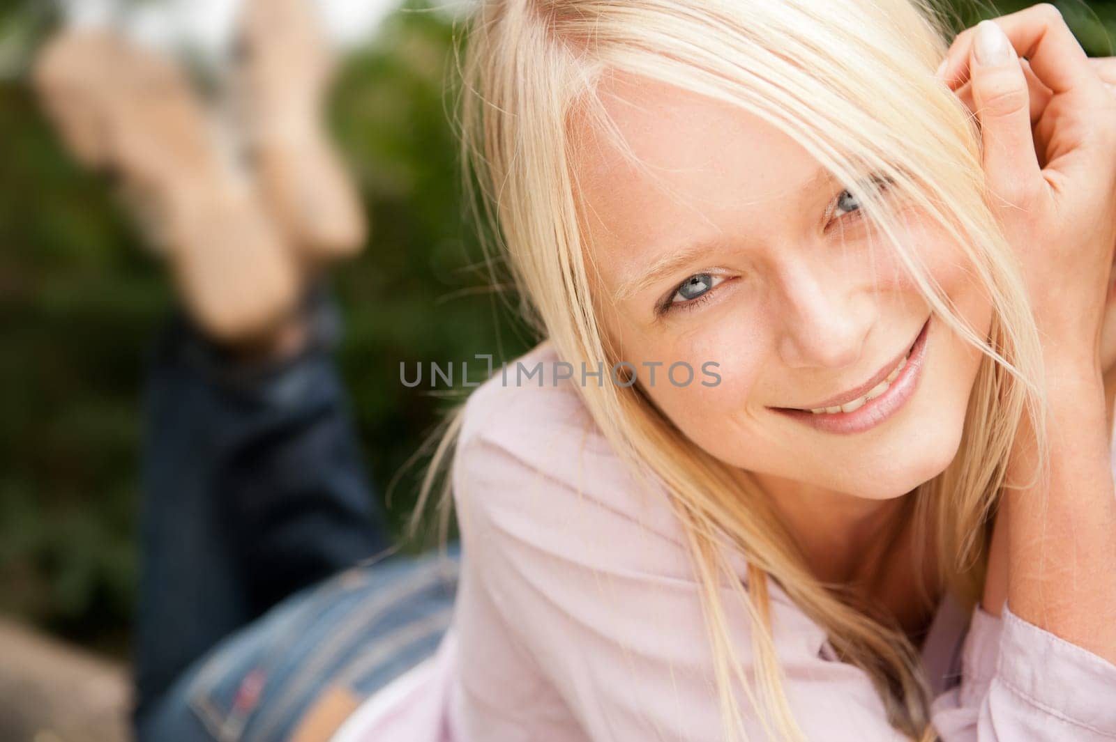 Portrait of a young and smiling woman in the park