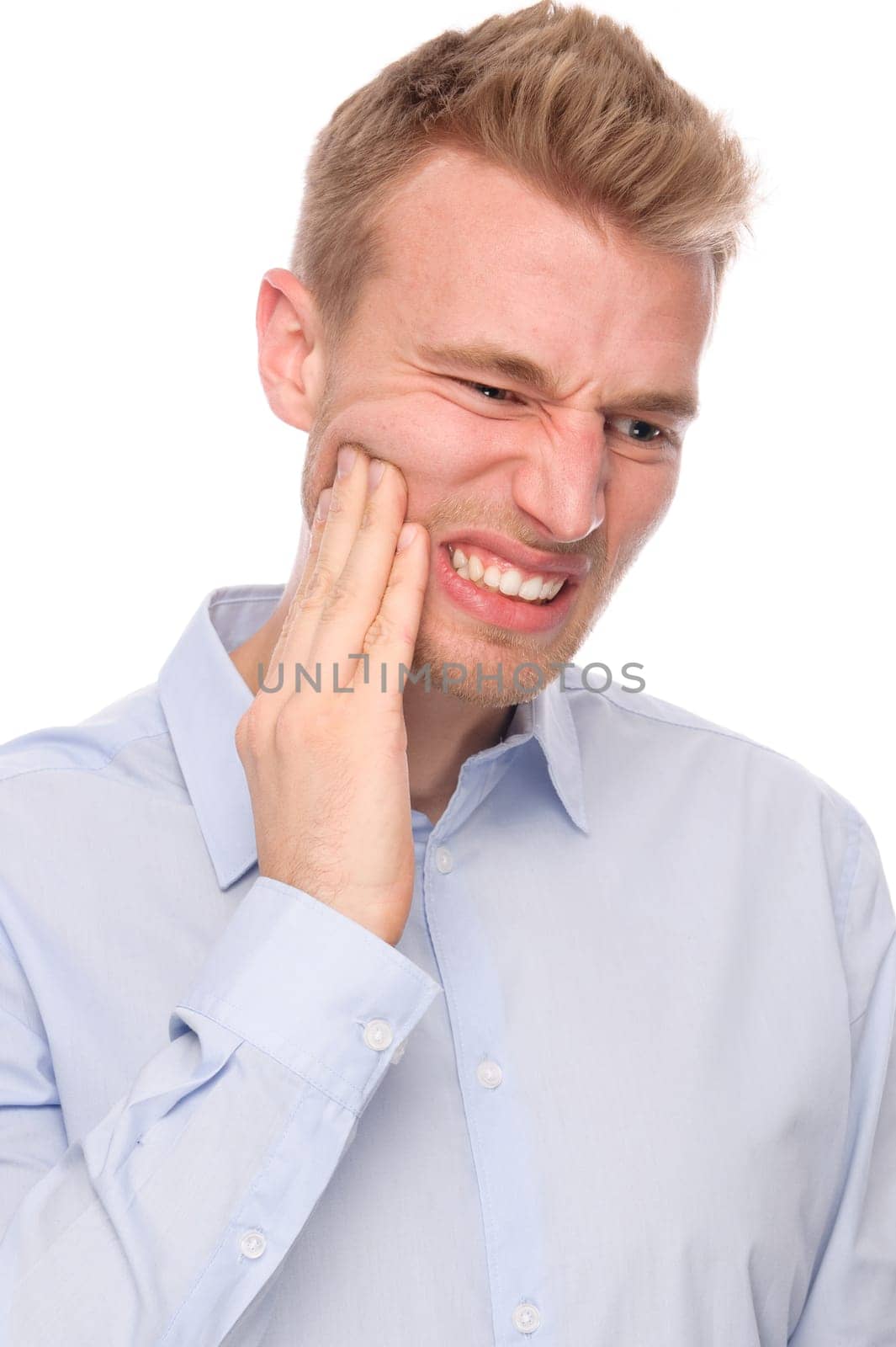 Studio shot of a young man with a headache