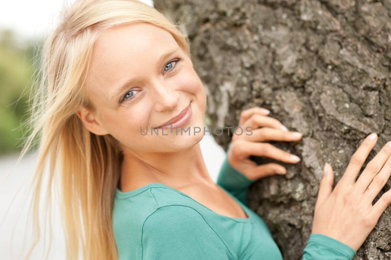 Portrait of a young and smiling woman in the park