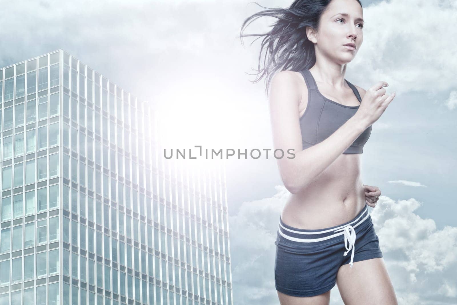 Young woman running in backlight in a city