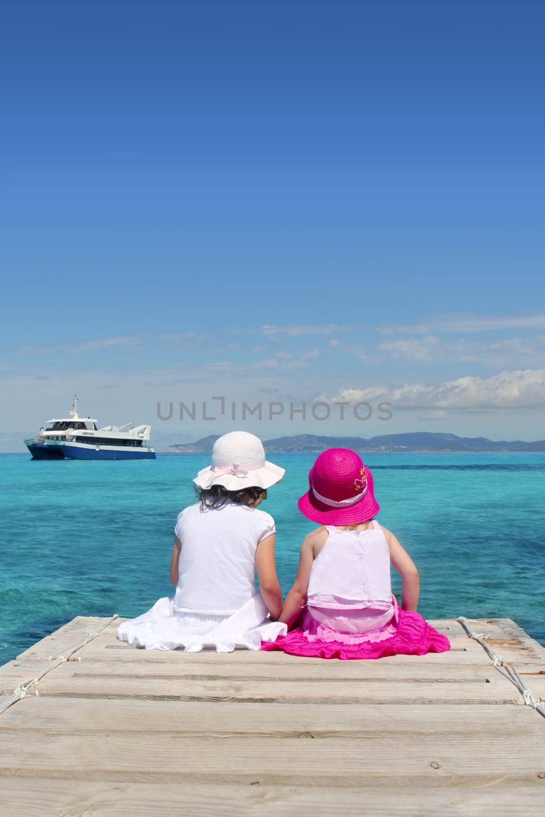 little sisters tourist turquoise sea back in Formentera