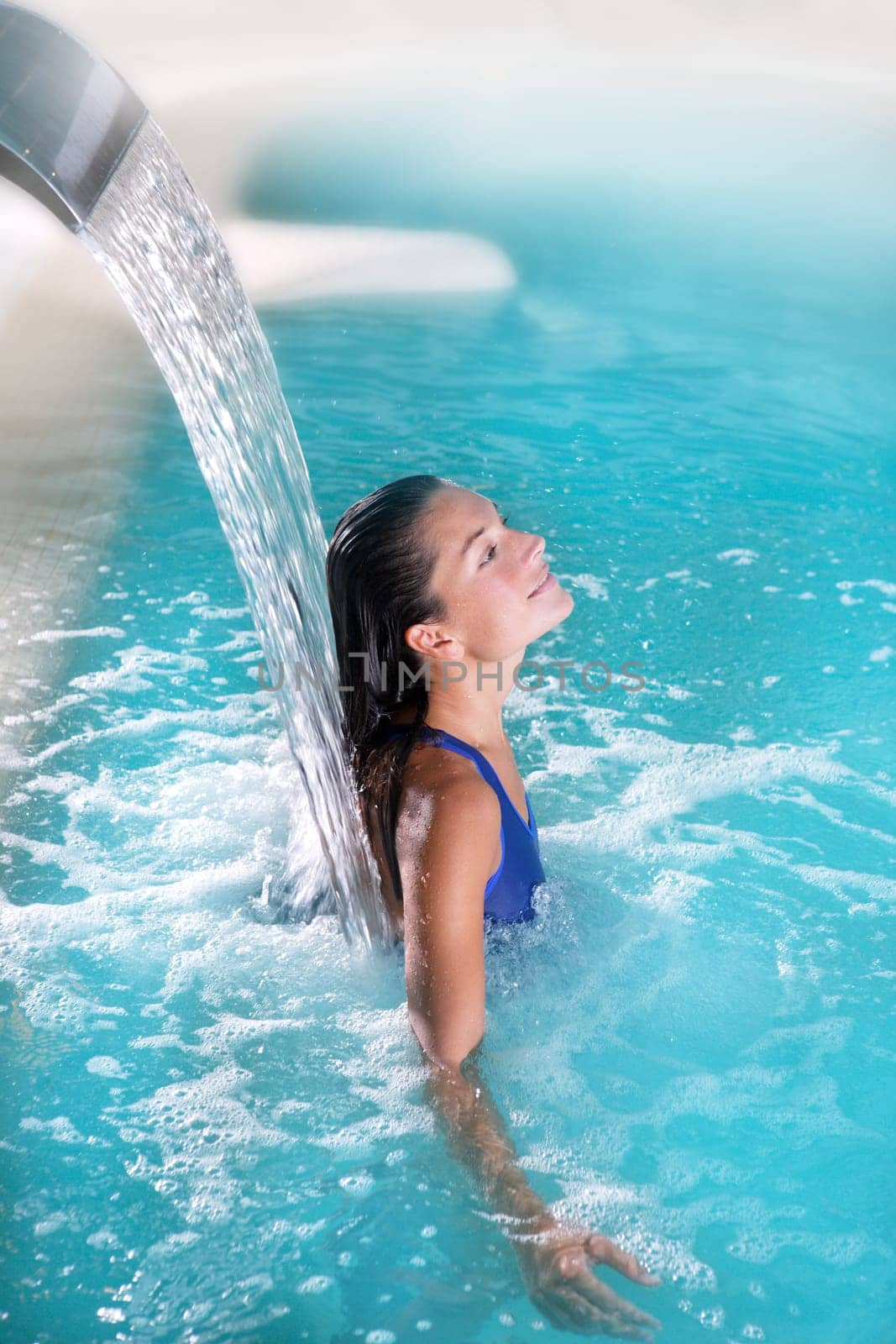 spa hydrotherapy woman waterfall jet turquoise swimming pool water