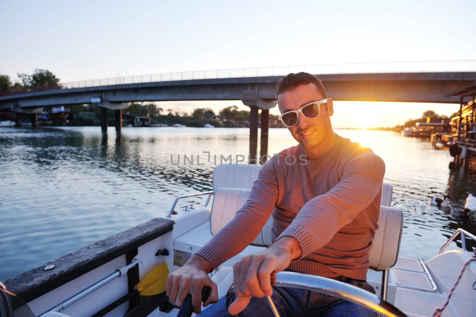 happy young couple in love  have romantic time at summer sunset   at ship boat while  representing urban and countryside fashin lifestyle