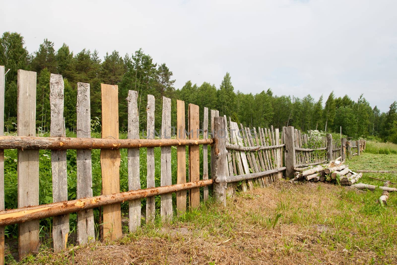 Old wooden fence repair at the countryside
