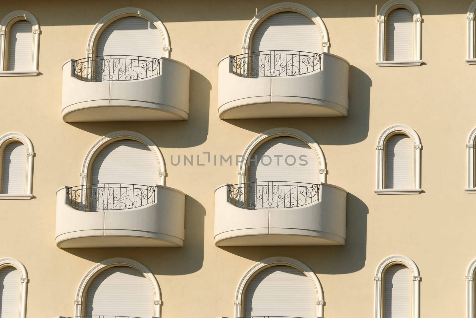 windows decorated with arches on the exterior of a building