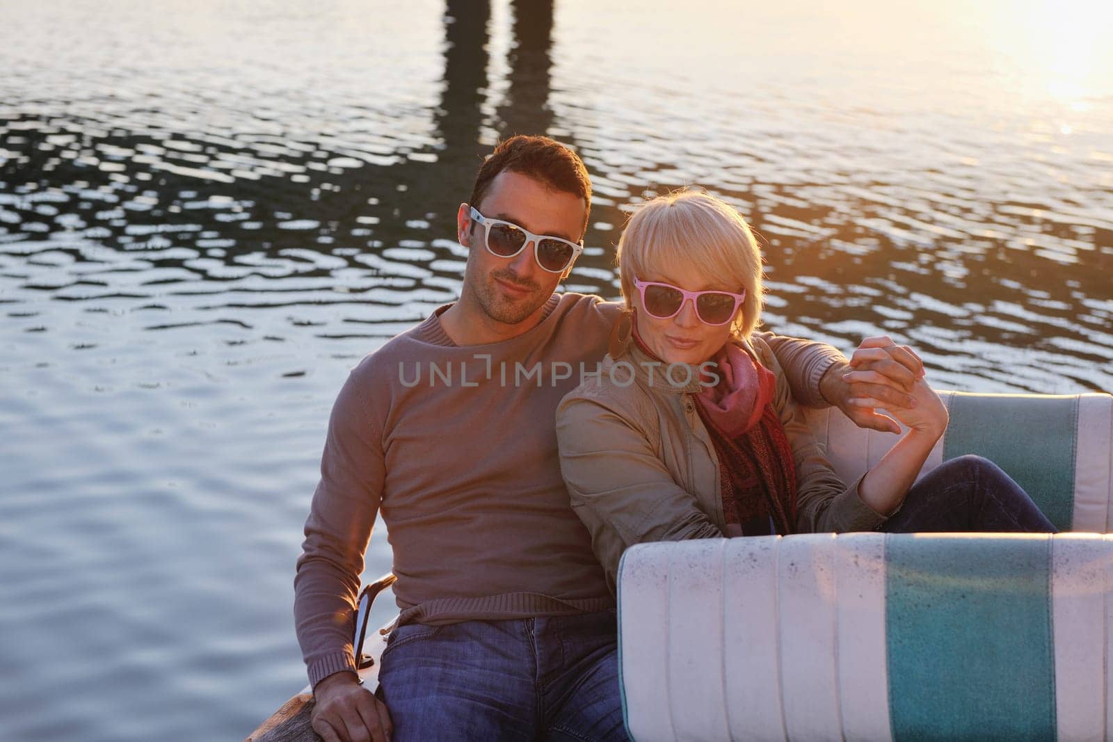happy young couple in love  have romantic time at summer sunset   at ship boat while  representing urban and countryside fashin lifestyle