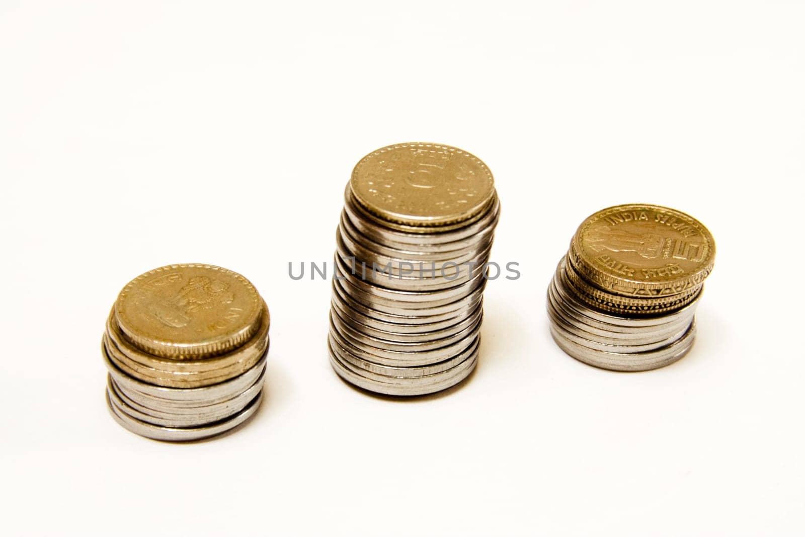 Coins arranged in three columns isolated on white background
