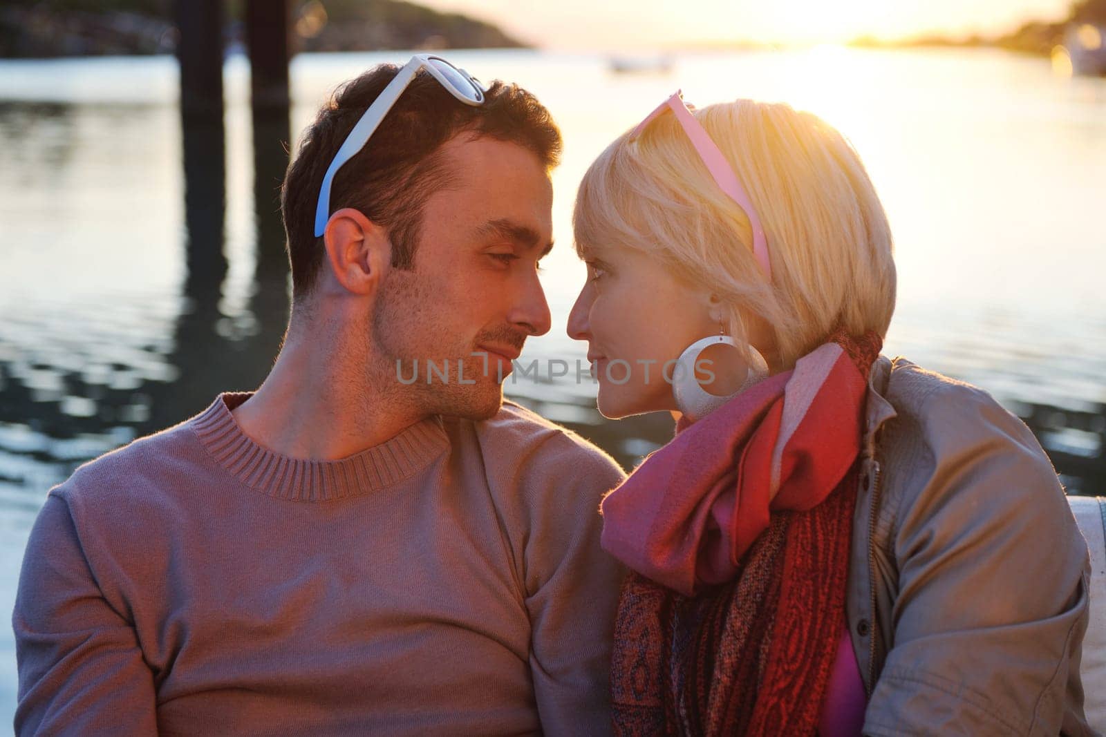 happy young couple in love  have romantic time at summer sunset   at ship boat while  representing urban and countryside fashin lifestyle