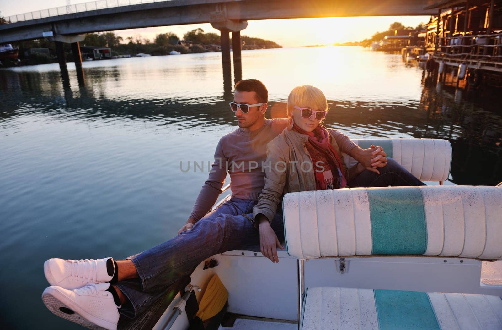 happy young couple in love  have romantic time at summer sunset   at ship boat while  representing urban and countryside fashin lifestyle