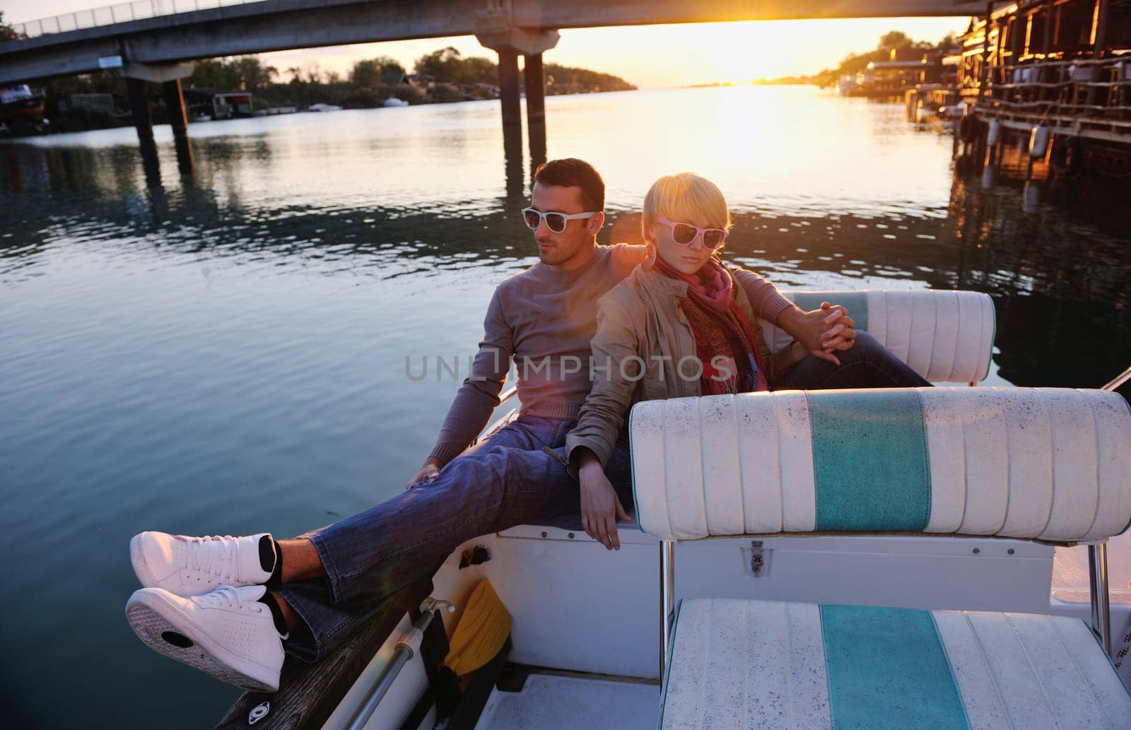 happy young couple in love  have romantic time at summer sunset   at ship boat while  representing urban and countryside fashin lifestyle