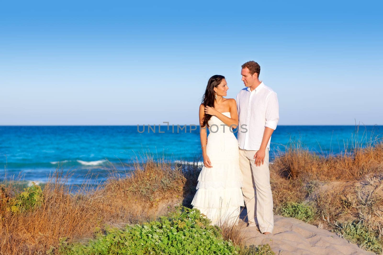 couple in love in the beach dune on Mediterranean sea
