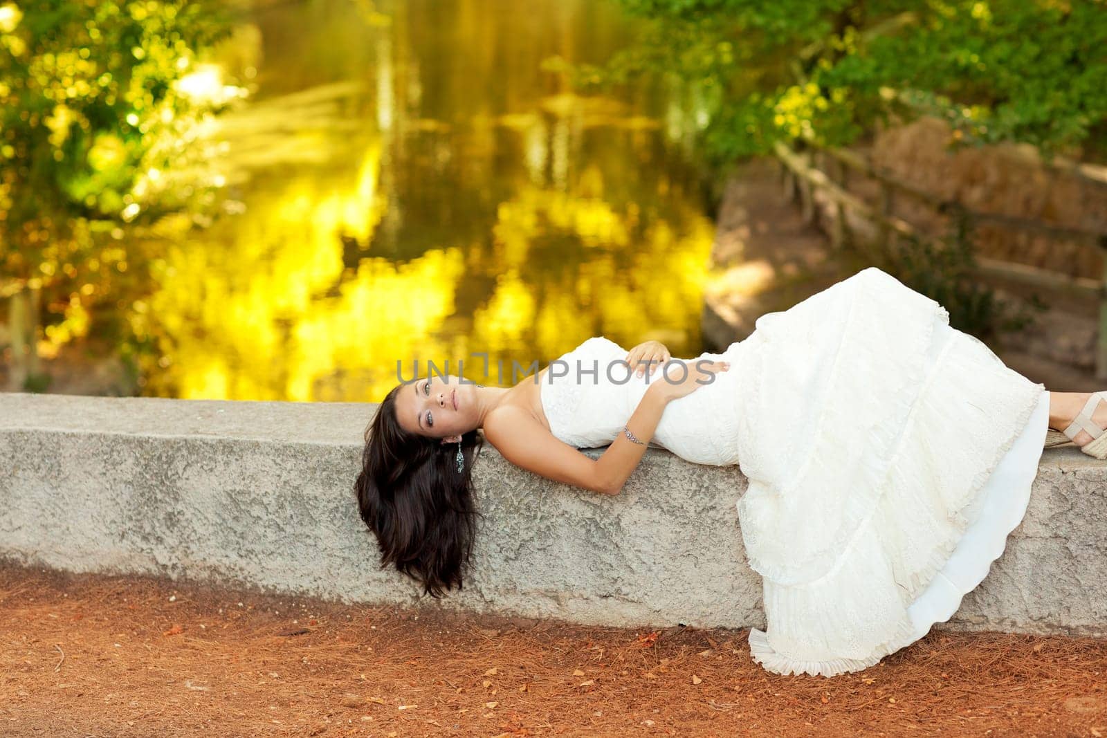 Woman lying in autumn golden forest river outdoor