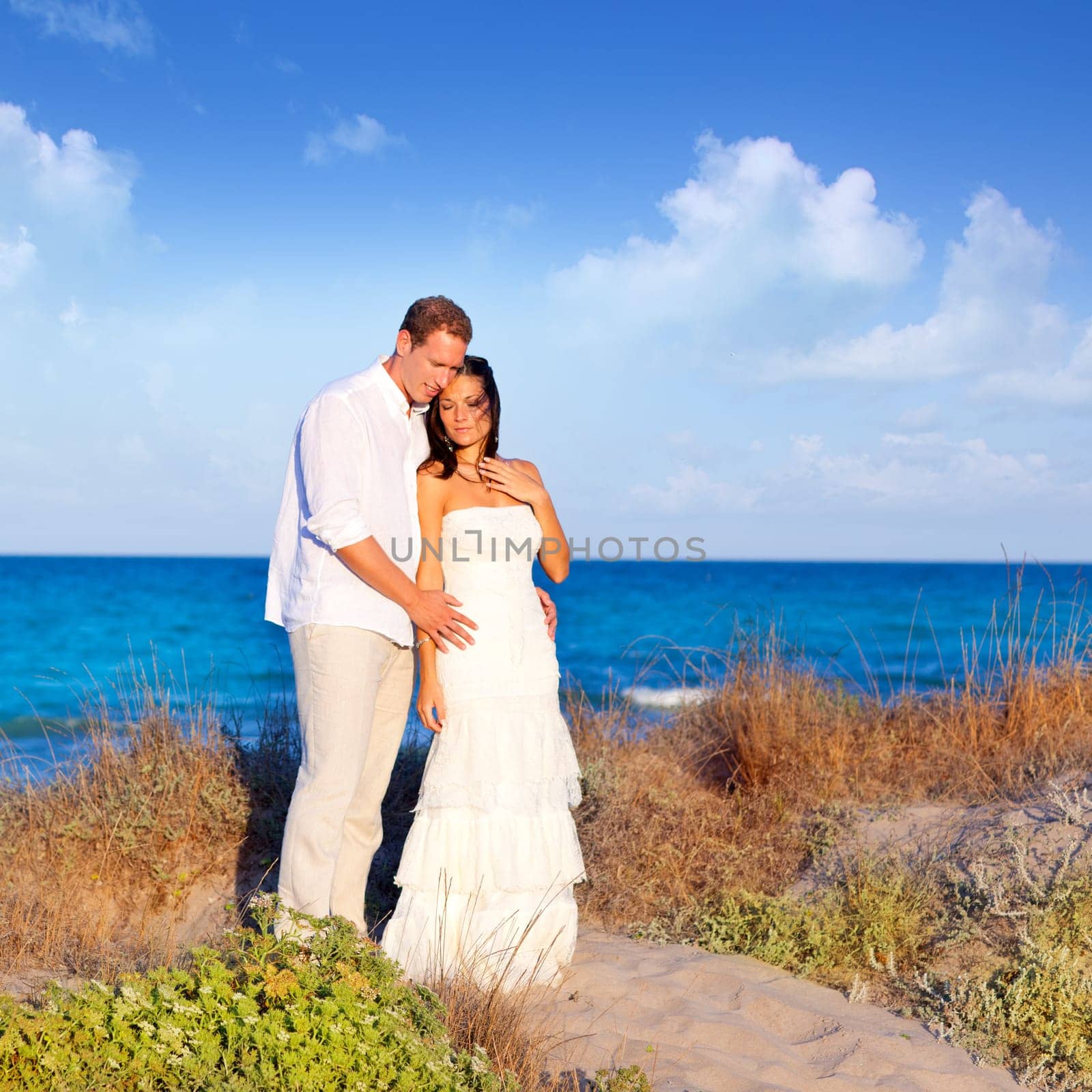 couple in love in the beach dune on Mediterranean sea