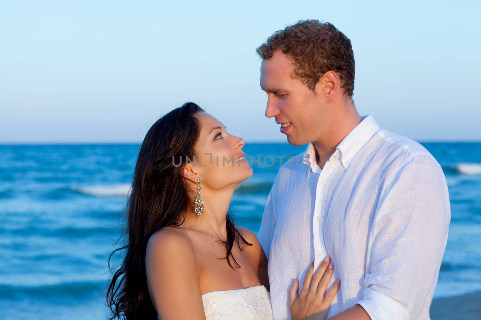 couple in love hug in blue sea vacation in Spain