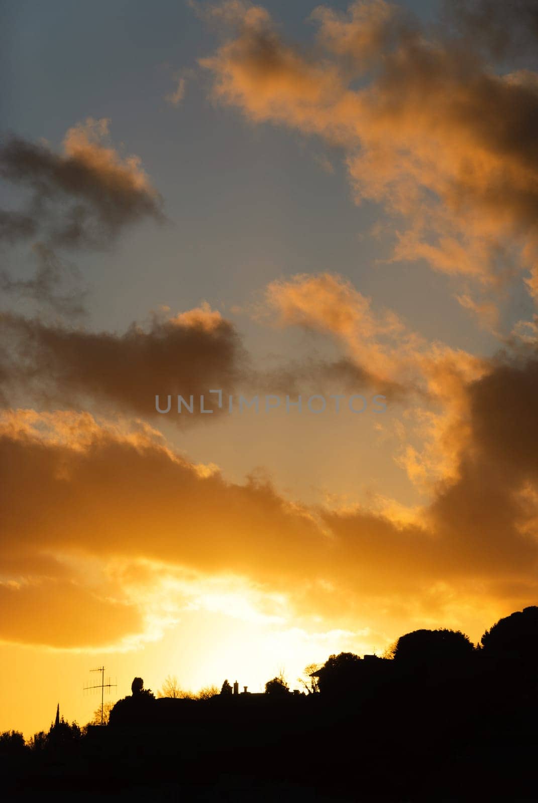 orange sunset with clouds in Genoa