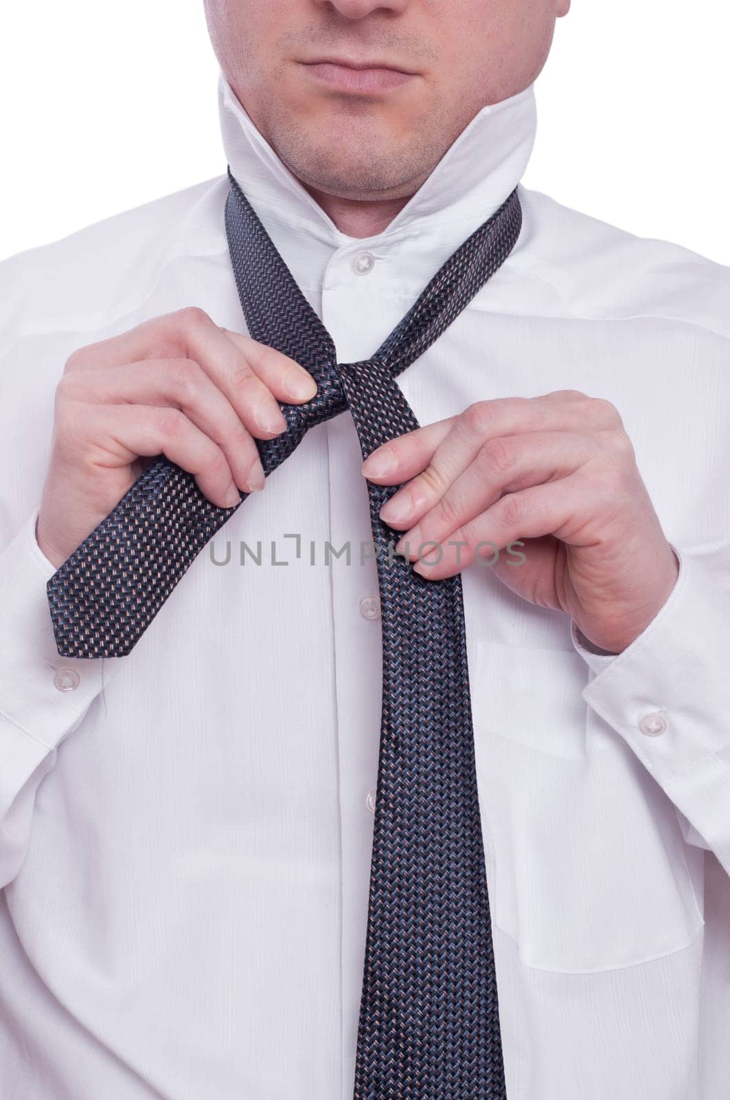 A man ties a tie