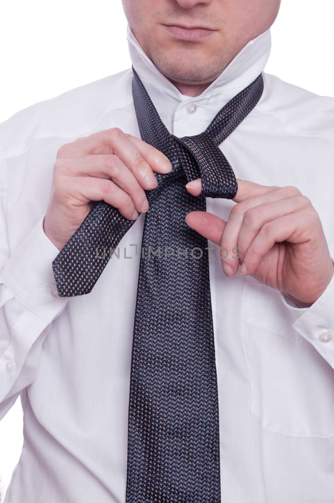 A man ties a tie