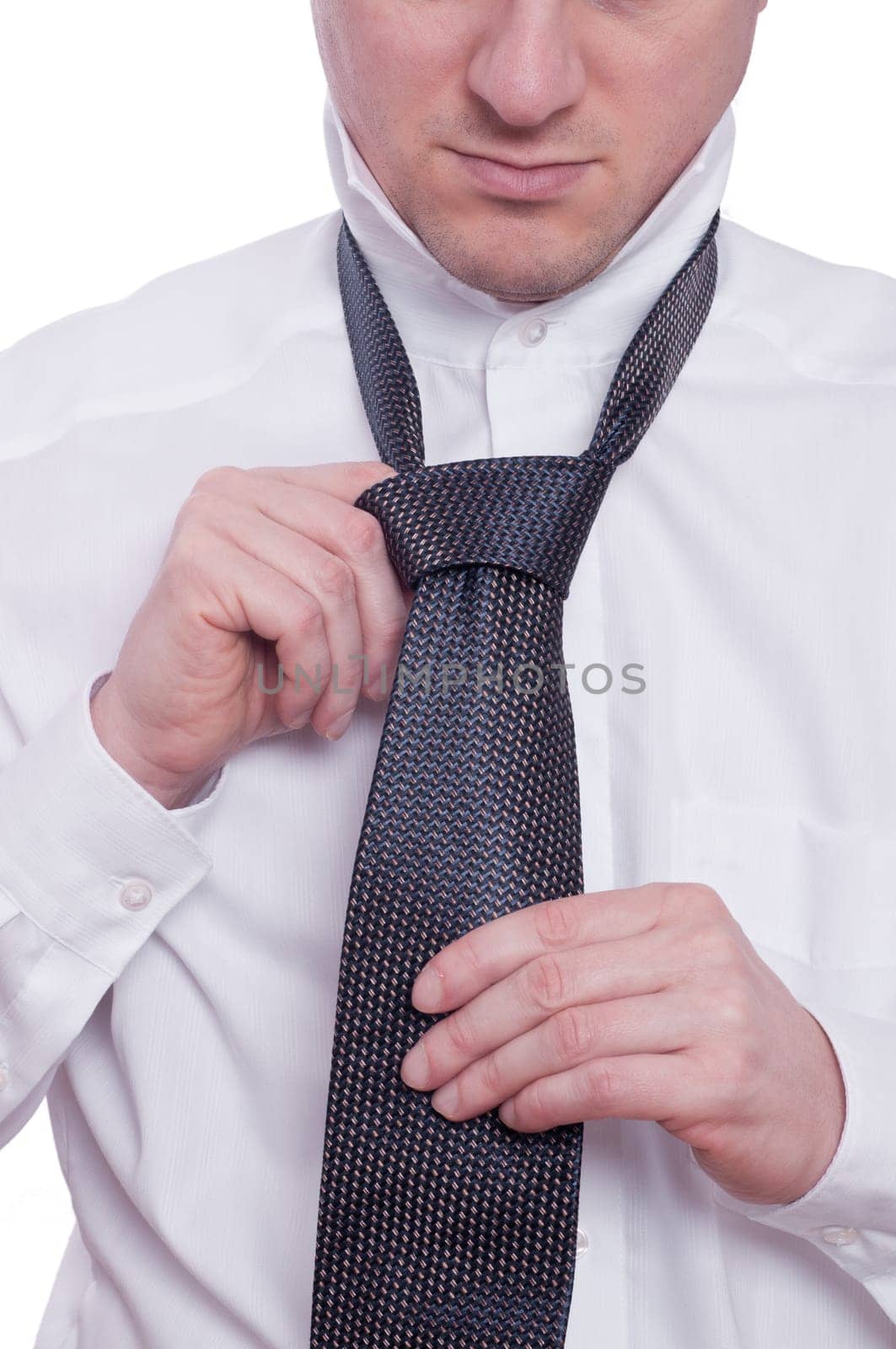 A man ties a tie