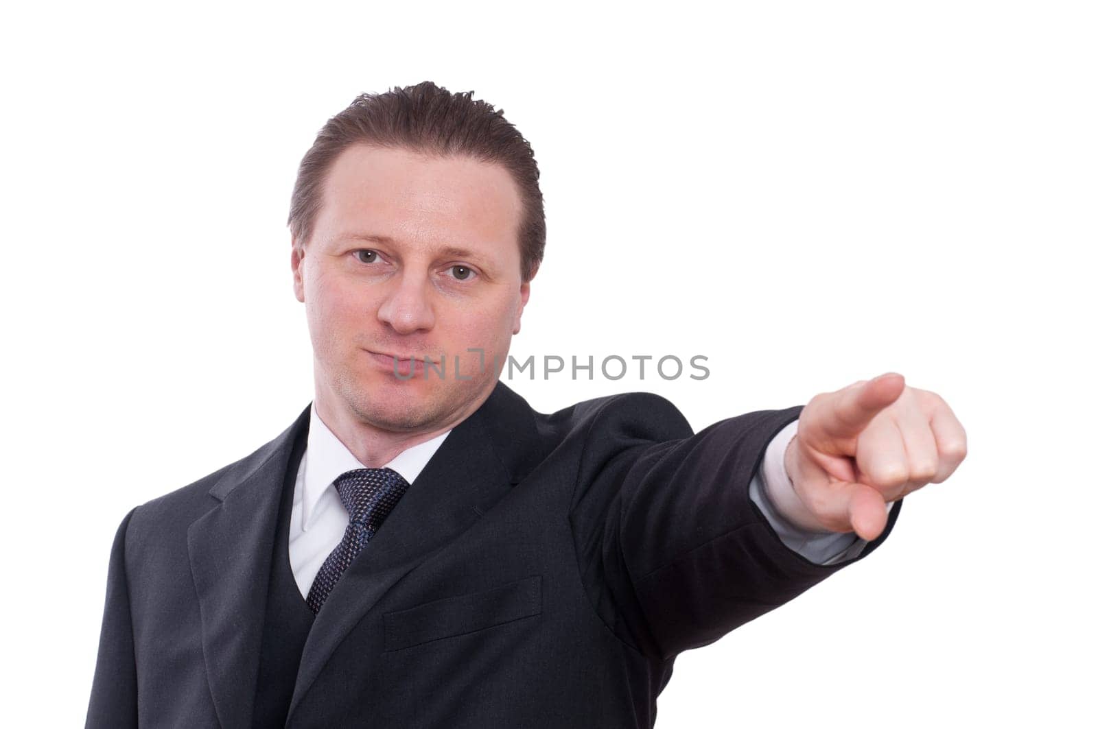 A man in a tie and suit points his index finger forward