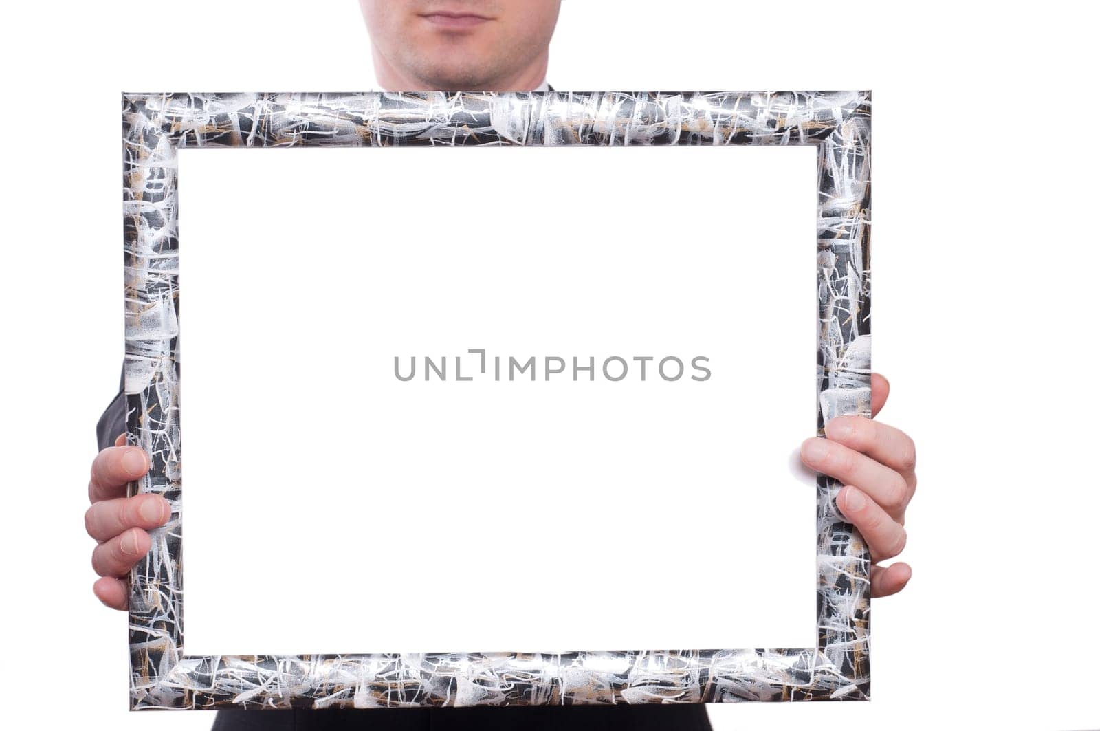 A picture frame with test space is held by two hands