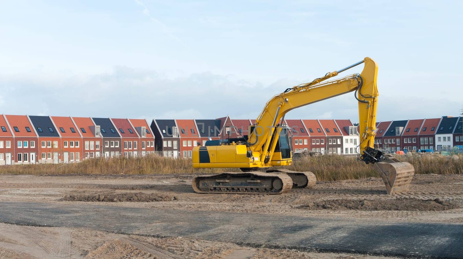 excavator in front of a newly build residential area