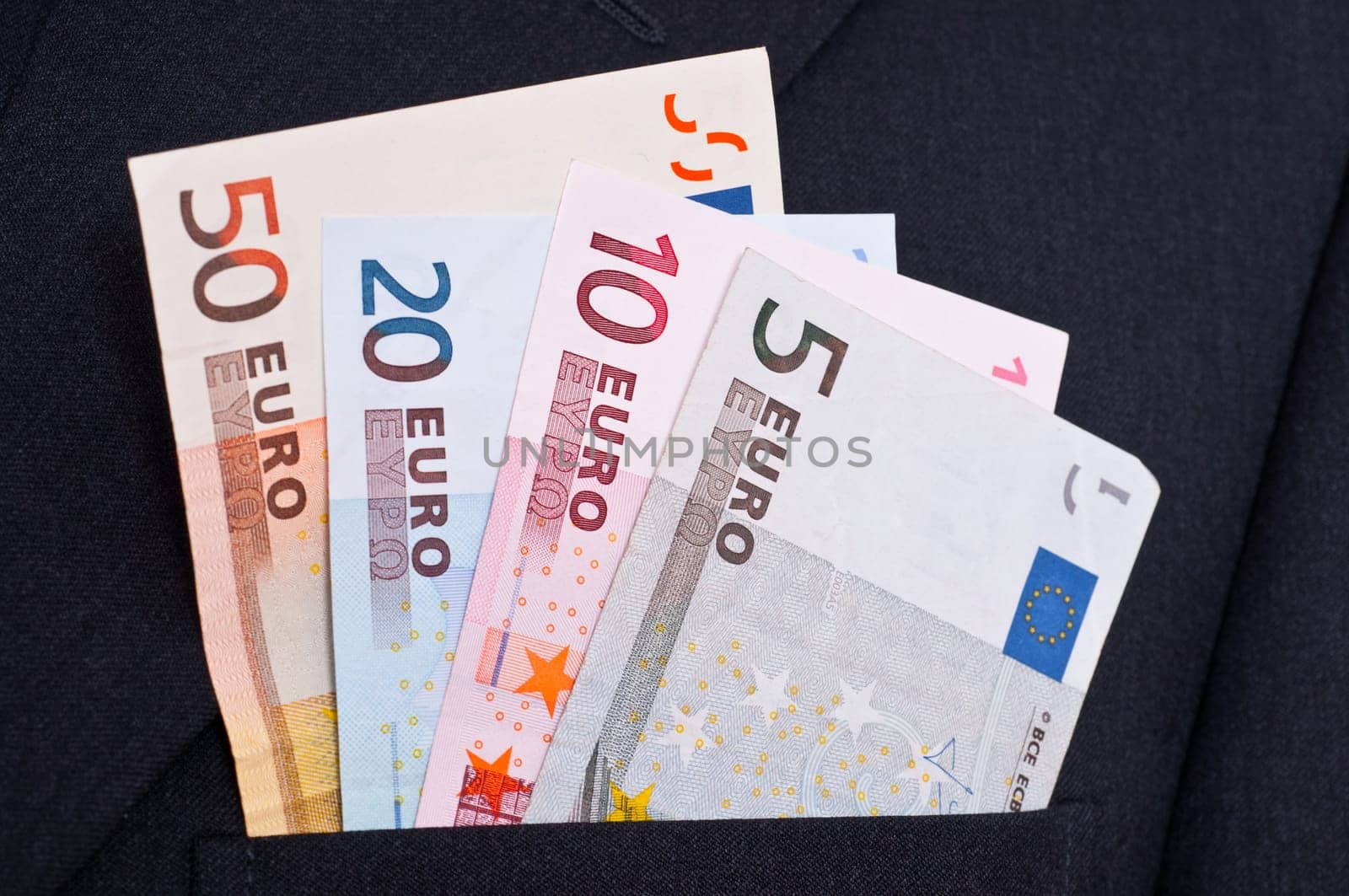 Euro bills stuck in the pocket of a suit