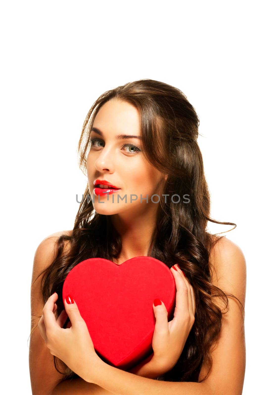 Beautiful woman holding red heart against white background